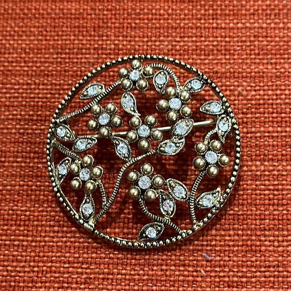 Antique brooch.  Gold tone with rhinestones.